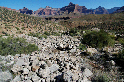 Crossing a boulder-strewn drainage below Marsh Butte