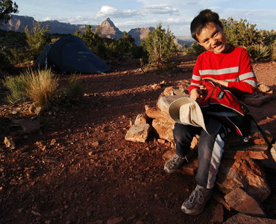 Sitting on the stone bench at camp